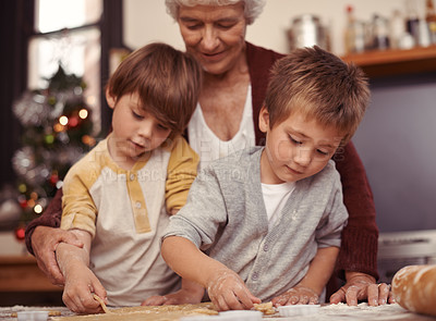 Buy stock photo Happy family, biscuits and baking in kitchen with cutter, home and learning of dessert cake with love. Grandma, teaching and boys of cookies on table, care and together on christmas holiday in house