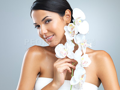 Buy stock photo Portrait, woman and beauty with flower in smile on studio, grey background and satisfied with makeup. Female person, soft and natural for smooth skin with eco friendly, sustainable and happiness. 