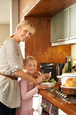 Buy stock photo Mother, daughter and cooking a salad in portrait, happy and kitchen for healthy meal in home. Girl, mommy and support in learning for child development, love and bonding with nutrition and vegan diet