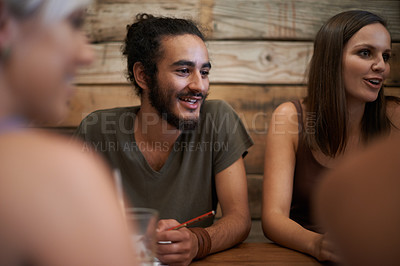 Buy stock photo Cropped shot of two young friends studying together at a coffee shop