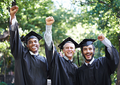 Buy stock photo Excited, students and portrait at graduation with fist, success and celebration of men outdoor with a smile. Fist pump, yes and education event on campus with diversity and college degree achievement