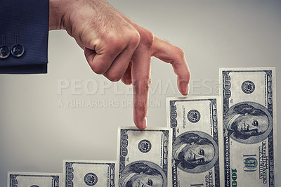 Buy stock photo Close up concept shot of fingers walking crawling up a pile of one hundred dollar bills