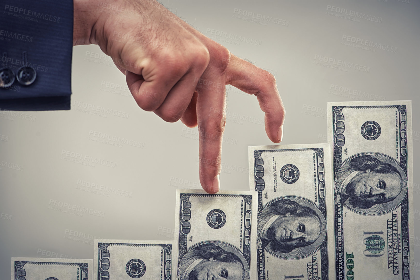 Buy stock photo Close up concept shot of fingers walking crawling up a pile of one hundred dollar bills