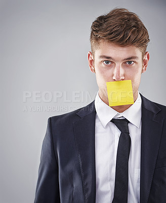 Buy stock photo Business man, sticky note and mouth in portrait for silence, reminder and studio by white background. Person, employee and corporate workout with paper on lips for compliance, censorship and quiet