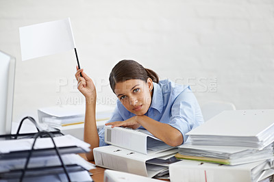 Buy stock photo Shot of a young businesswoman holding up a white flag and looking defeated