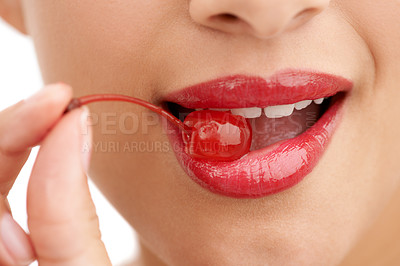 Buy stock photo Woman, mouth and bite with cherry, red lipstick or cosmetics for nutrition on a white studio background. Closeup of person, teeth or natural organic fruit with makeup or gloss for diet, fiber or glow