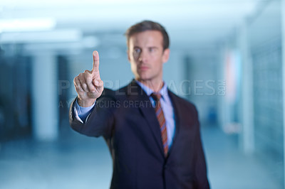 Buy stock photo Cropped shot of a handsome young business professional using a digital interface