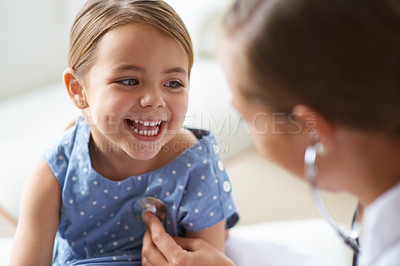 Buy stock photo Happy girl, kid and pediatrician with stethoscope for medical consulting, healthy lungs and listening to heartbeat. Face of child, doctor and chest assessment, healthcare analysis and smile in clinic