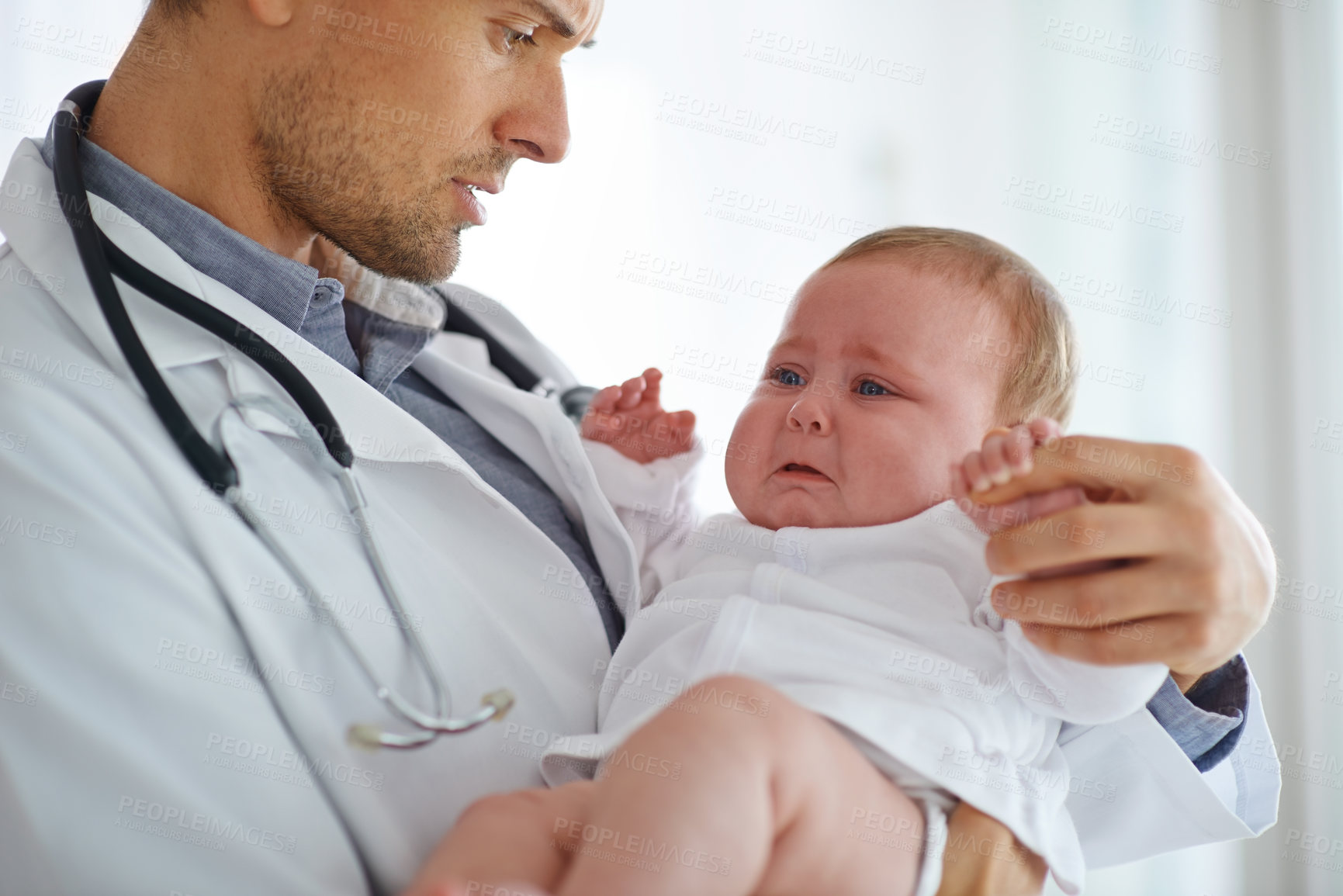 Buy stock photo Doctor, pediatrician and crying baby in clinic for medical assessment, support and growth. Sad, scared and sick newborn kid with pediatrics physician for healthcare service, hospital test or wellness