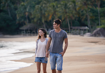 Buy stock photo Holding hands, walking and couple on beach for vacation, adventure or holiday for tropical travel. Nature, love and young man and woman by ocean or sea for romantic date on weekend island trip.