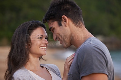 Buy stock photo Love, happy and couple on island for date on romantic anniversary vacation, adventure or holiday. Smile, bonding and young man and woman embracing with care by ocean on weekend trip together.