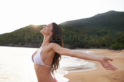 Buy stock photo Outdoor, hands up or happy woman at sea for travel adventure to relax on holiday vacation. Bikini, peace or female person at beach with open arms in nature for fresh air, freedom or gratitude in Bali