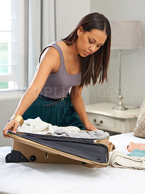 Buy stock photo Travel, clothes and woman packing luggage for vacation, holiday and planning in home. Bedroom, serious person and suitcase for trip preparation, journey or getting ready for tourism with bag on bed