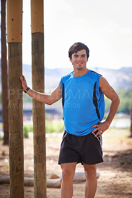 Buy stock photo Shot of a handsome young man exercising outdoors