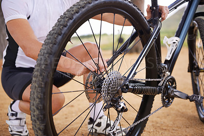 Buy stock photo Cropped shot of a man adjusting his bicycle chain