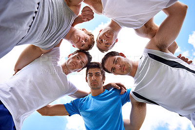 Buy stock photo Shot of a group of fit young sportsmen standing in a huddle