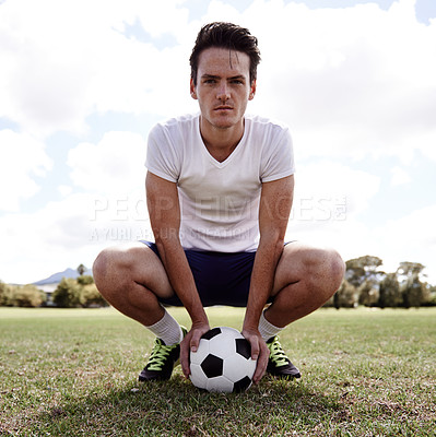 Buy stock photo Man, soccer ball and portrait on ground for sports with pride, confidence and ready for challenge on field. Person, athlete and football player on grass for exercise, workout and training for game
