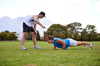 Buy stock photo Men, push up and personal trainer on grass for workout with clipboard for test, progress or development. Person, coach or mentor with motivation for results, training or exercise for health on field