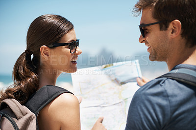 Buy stock photo Couple, map and search in summer by ocean, outdoor or smile to check direction for help on vacation. Woman, man and chart at location, landmark or reading with thinking on holiday at beach in Italy