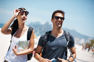 Buy stock photo Couple, tourist and smile with map for direction on vacation, trip and happiness in Brazil. Relationship, holiday and bonding at beach for summer with adventure and travel for tour and break.