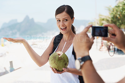 Buy stock photo Young woman enjoying a drink from a coconut