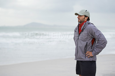 Buy stock photo Fitness, man and thinking break at a beach after training, running or winter morning cardio in nature. Workout, recovery and male runner at the sea for sports rest, breathing or body wellness routine