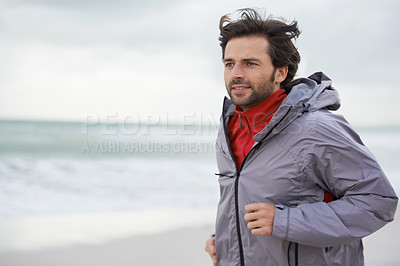 Buy stock photo Beach, man or running for workout, training or wellness outdoor in nature to exercise for body health. Ocean, athlete or person jog for fitness, cardio or sport with energy at sea in winter on mockup