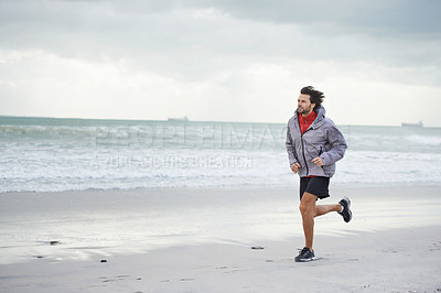 Buy stock photo Beach, man or running for workout, sport or wellness outdoor in nature to exercise for body health. Ocean, athlete or person jog for fitness, cardio or training with energy at sea in winter on mockup