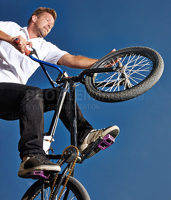 Buy stock photo Cropped shot of a teenage boy riding a BMX at a skatepark