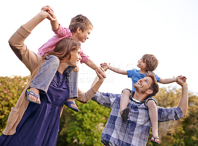 Buy stock photo Excited, nature and children on parents shoulders in outdoor park or field for playing together. Happy, bonding and young mother and father carrying boy kids for fun in garden in Canada for summer.