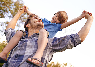 Buy stock photo Happy, nature and kid on father shoulders in outdoor park or field for playing together. Smile, bonding and young dad carrying cute boy kid for fun, love and care in garden in Canada for summer.