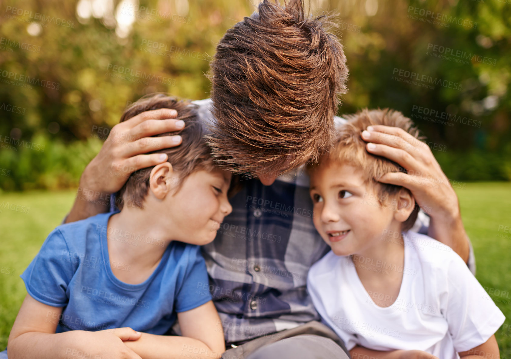 Buy stock photo Smile, nature and young children with father relaxing on grass in outdoor park or garden. Happy, love and excited boy kids sitting on lawn with dad for love, care and bonding in field together.