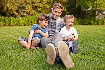 Buy stock photo Smile, nature and portrait of kids with father relaxing on grass in outdoor park or garden. Happy, family and excited boy children sitting on lawn with young dad for bonding in field together.