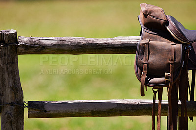 Buy stock photo Cropped shot of a saddle on a fence