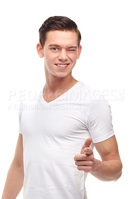 Buy stock photo Portrait, wink and male student with pointing, flirting and isolated on white background. Smile, funny or goofy and comic with confident young learner, university and cheerful Italian man in studio
