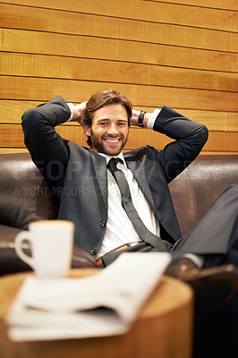 Buy stock photo A happy businessman relaxing on a couch in a coffee shop