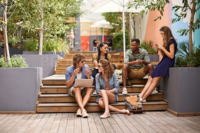 Buy stock photo Students, talking and laptop or relax on break, campus and browse on social media for update. People, diversity and technology at university for online research and cellphone to scroll or networking