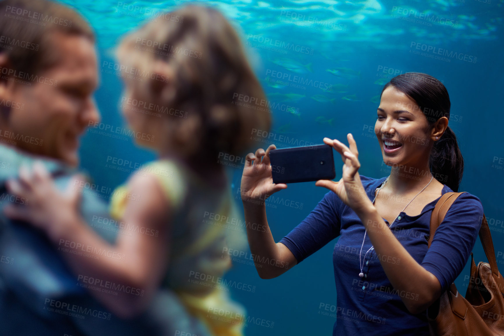 Buy stock photo Aquarium, woman or phone for photo, family or outing for fun, happy or bonding together in Brazil. People, smartphone and fish tank for social media, exploration and marine life on playful weekend
