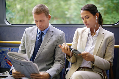 Buy stock photo Bus, business people and commute to work on transportation, reading newspaper and tablet for info. Woman, earphones and online for social media or travel, newsletter and man for article on transit