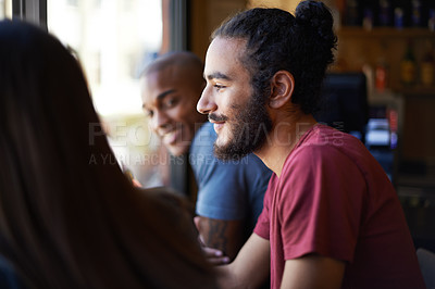Buy stock photo A cropped shot of young friends socializing at a bar