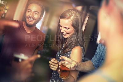 Buy stock photo Shot of friends drinking and having fun in a pub