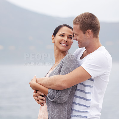 Buy stock photo Couple, hug on beach and smile for travel, fresh air with ocean and happiness together outdoor. Romantic adventure, love and affection for bonding, support and trust with commitment on holiday