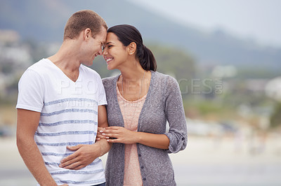 Buy stock photo Couple, hug and walking on the beach for travel, forehead touch and happiness together outdoor. Romantic adventure, love and affection for bonding, support and trust with commitment on holiday