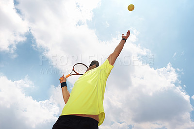 Buy stock photo Shot of a male tennis player about to serve