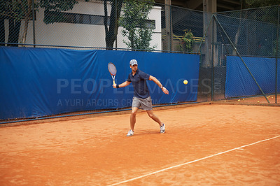 Buy stock photo Exercise, sports or tennis and man with racket hitting ball on court for competition, game or match. Fitness, health and training with confident young athlete person outdoor in summer for action
