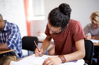 Buy stock photo Man, class and writing in college, learning and knowledge on campus for education. Student, male person and notes for information in book, planning and research for studying or revision for exams