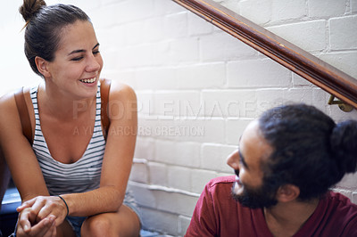 Buy stock photo Campus, woman and man together on stairs with smile, backpack and classmates as friends. University, school and people in course for education with scholarship, laughing and conversation to relax
