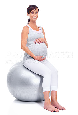 Buy stock photo A pregnant mother smiling with a pilates ball while isolated on white