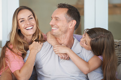 Buy stock photo Mom, dad and girl on sofa with smile, embrace and relax in playful bonding together in family home. Mother, father and daughter on couch with love, weekend fun and care for happy man, woman and child