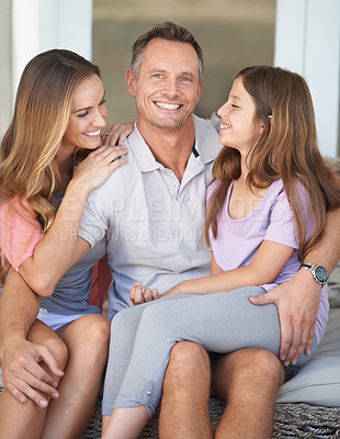 Buy stock photo Dad, girl and mom in portrait on patio with hug, care and love with dad with smile at family home. Father, mother and daughter with embrace, connection or happy to relax together in backyard at house